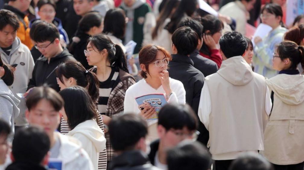 College students are looking for jobs at a spring job fair at Siyuan Square on the Xiangshan campus of Huaibei Normal University in Huaibei, China, on March 21, 2024. 