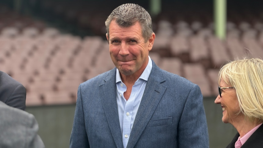 Mike Baird looks at the camera as he purses his lips.
