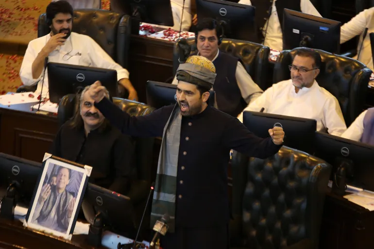 epa12451797 Sohail Afridi (R), of Pakistan Tehreek-e-Insaf (PTI), with former CM Ali Amin Gandapur (L) in front of a portrait of jailed former Prime Minister Imran Khan, talks with assembly members after being elected the new Chief Minister of Khyber Pakhtunkhwa province in Peshawar, Pakistan, 13 October 2025. Pakistan Tehreek-e-Insafs Sohail Afridi was elected chief minister of Khyber Pakhtunkhwa on Monday, securing 90 votes in the provincial assembly session held amid tight security in Peshaw