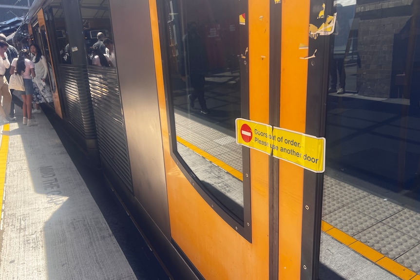 A train door closed with tape across it.