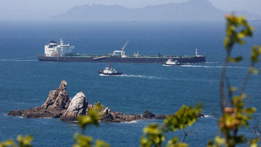 Tugboats guide the crude oil tanker Odessa, carrying UAE crude after passing through the Strait of Hormuz at Daesan port. (REUTERS FILE)