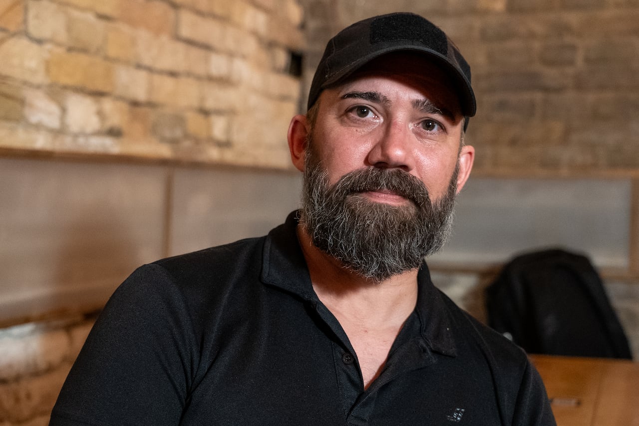 A man looks on towards the camera.