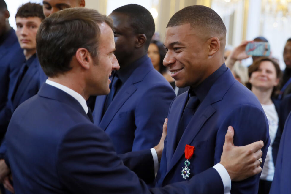 French president Emmanuel Macron awards the Legion of Honour medal to football player Kylian Mbappe at the Élysée Palace in Paris on June 4, 2019