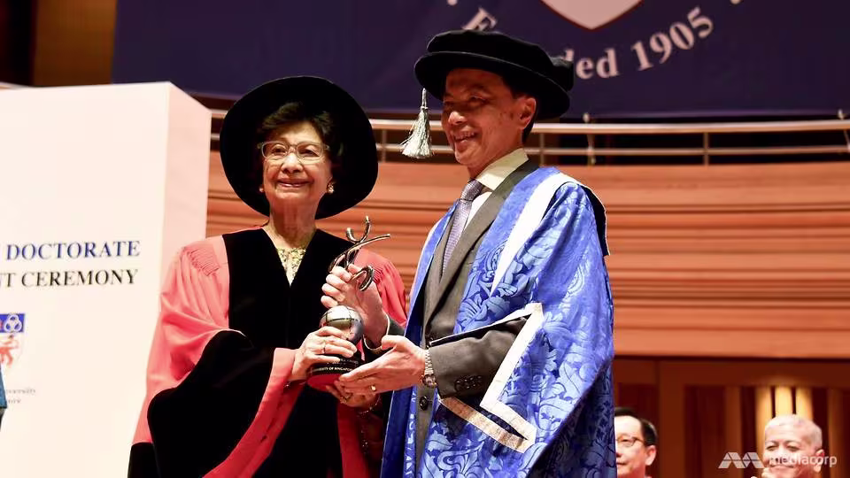 Dr Siti Hasmah (left) presented with the NUS Distinguished Alumni Service Award in 2018. (Photo: CNA/Hanidah Amin)