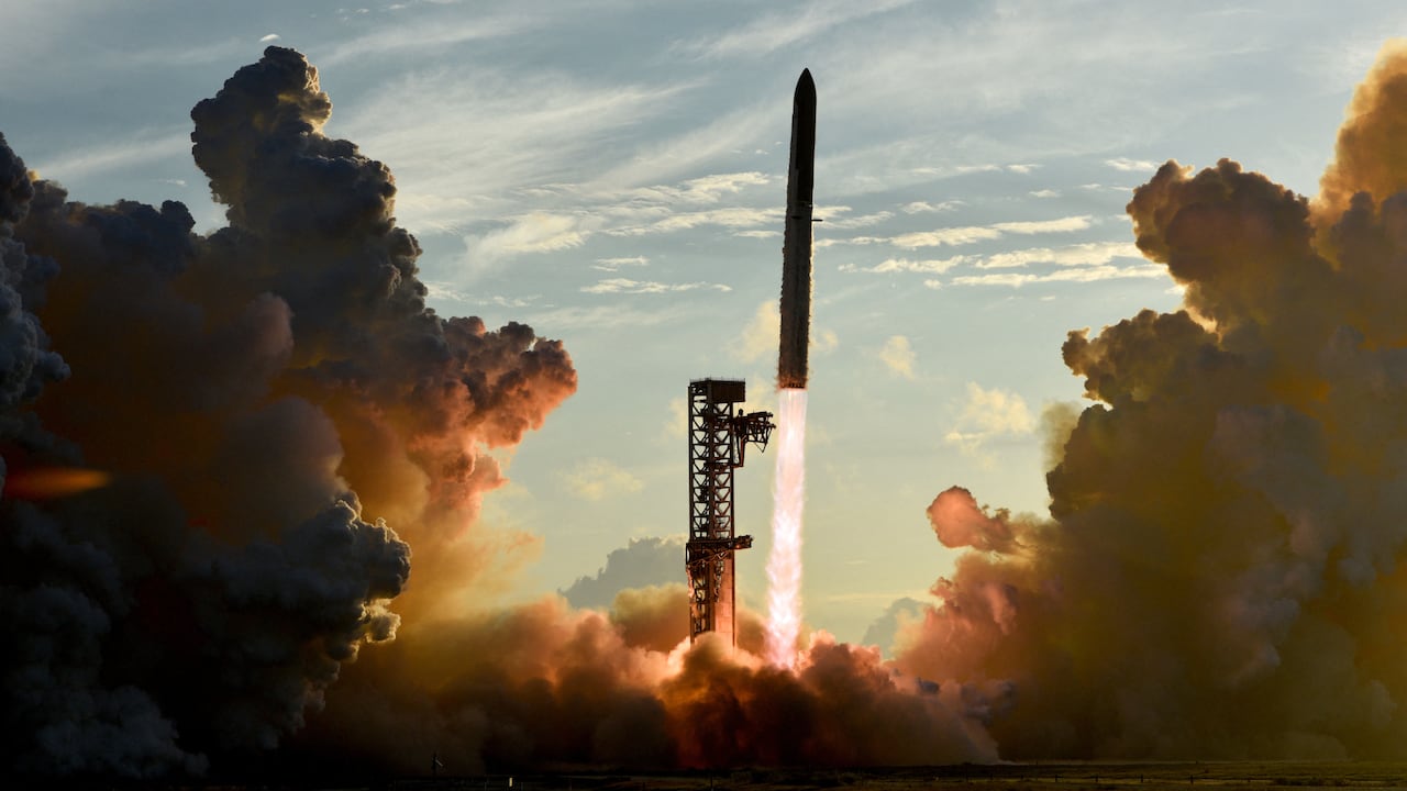 A giant rocket lifts off from a launch pad.