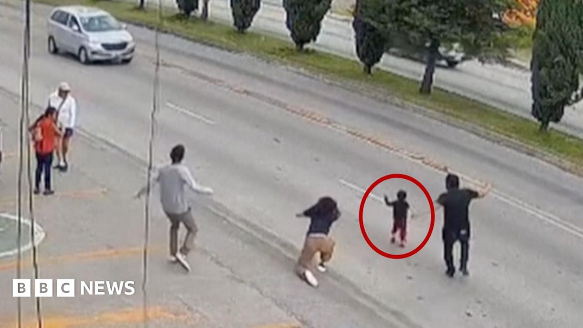 Lucky toddler has a narrow escape after running into speeding traffic
