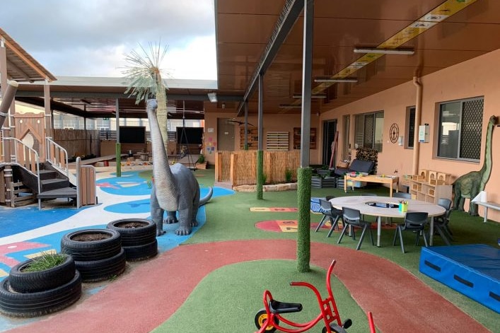 Inside a childcare centre with playground and desks