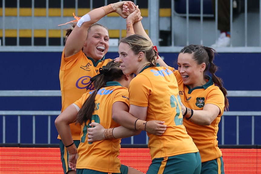 Wallaroos players celebrate a try against Scotland.