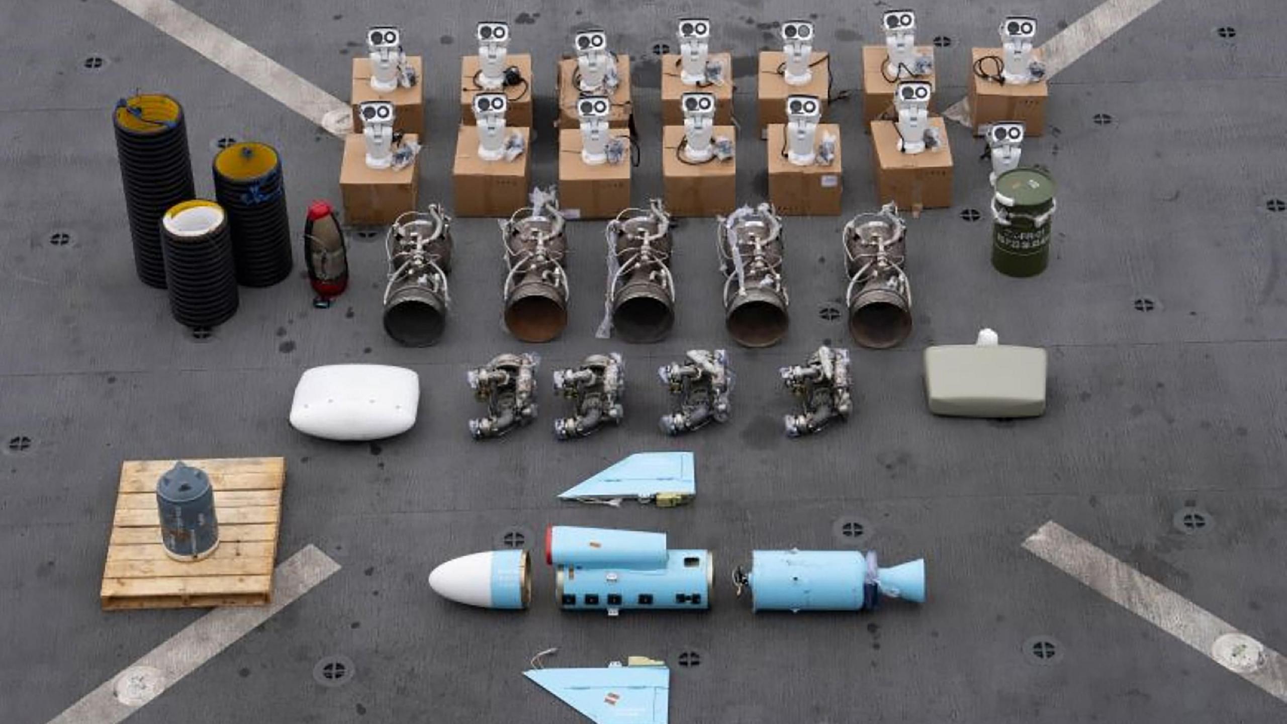 Several rows of weapons parts displayed on the deck of a ship - photo from January 2024