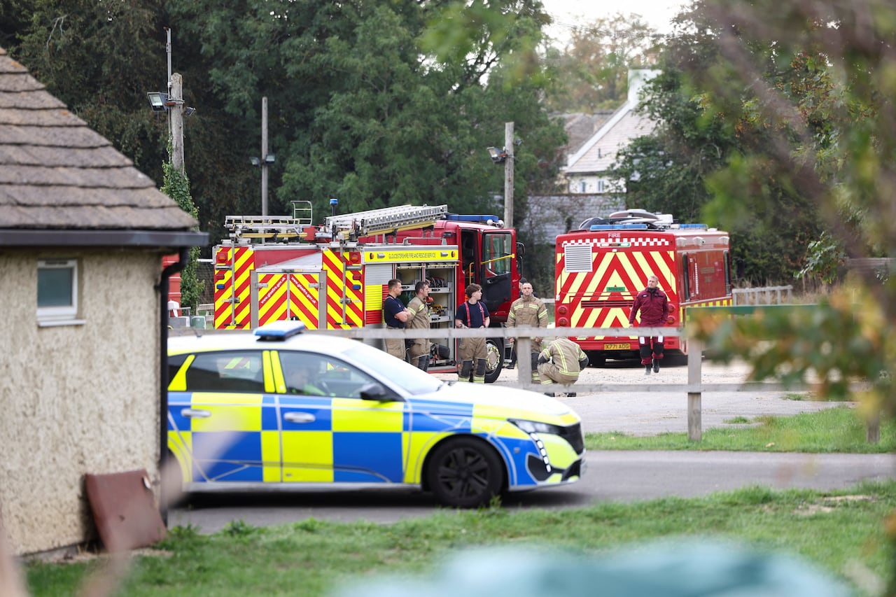 Emergency vehicles parked outside of houses.