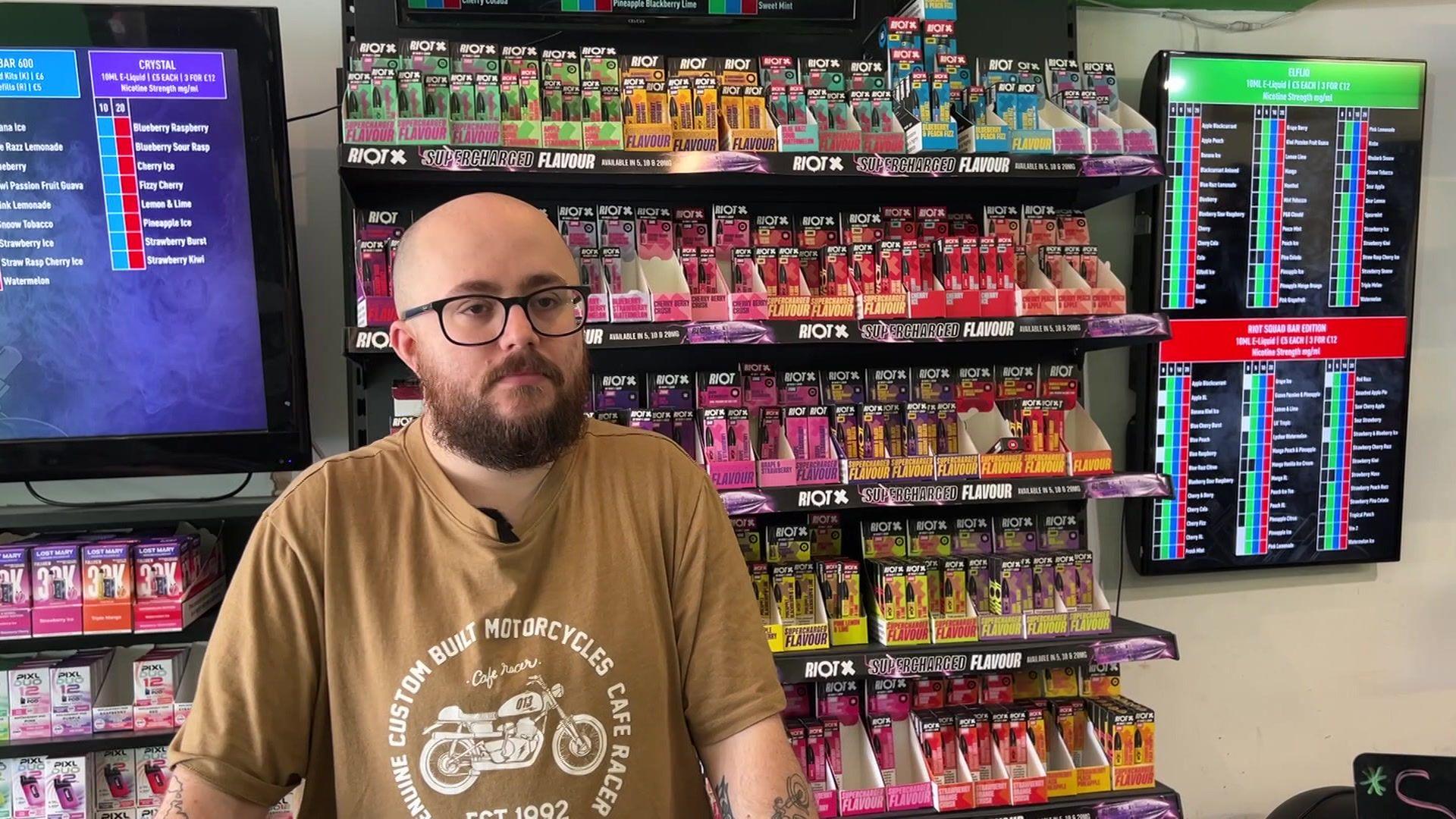 Jordan standing at a counter in a vape shop