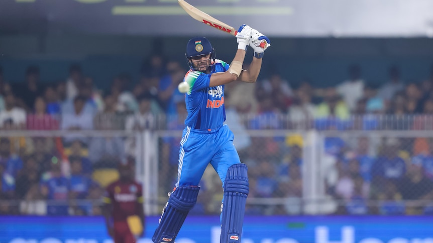 Cricket batter hits the ball through the offside, ball is coming towards the camera, batter watches intently