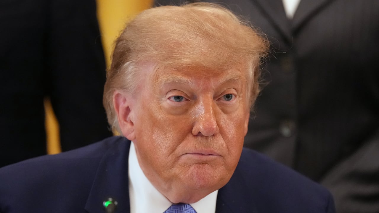 Close up of man with yellow hair in blue suit