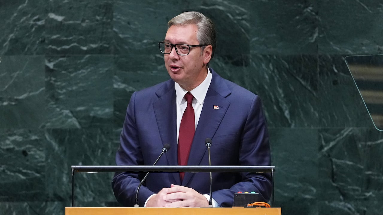 A person speaks at a lectern.