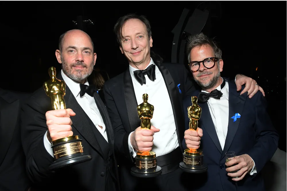 Edward Berger, Volker Bertelmann and Christian Goldbeck after their 2023 Oscar wins Courtesy of Charley Gallay/Getty Images for Netflix
