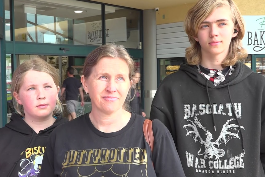 April Shortis pictured outside some shops with her son and daughter in Horsham.