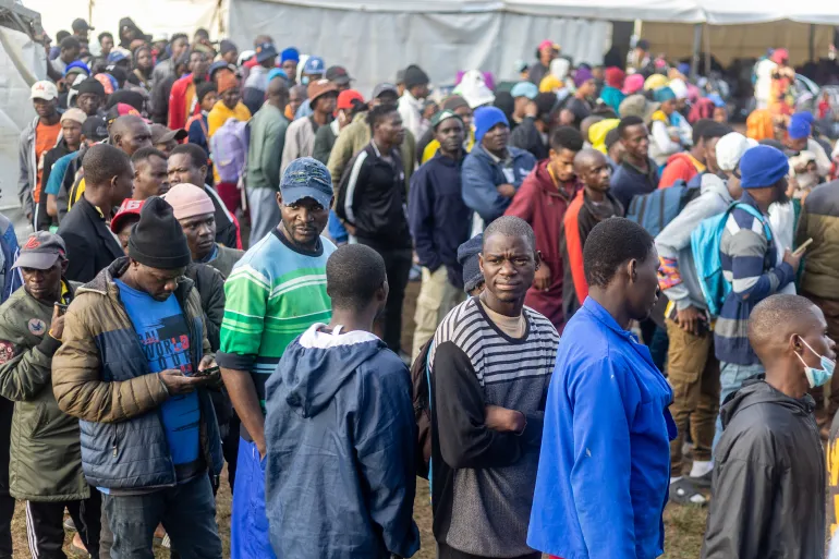 Malawi migrants to South Africa line up for supplies at an informal refugee camp in Sherwood, Durban, South Africa, after fleeing their homes amid fears of xenophobic attacks