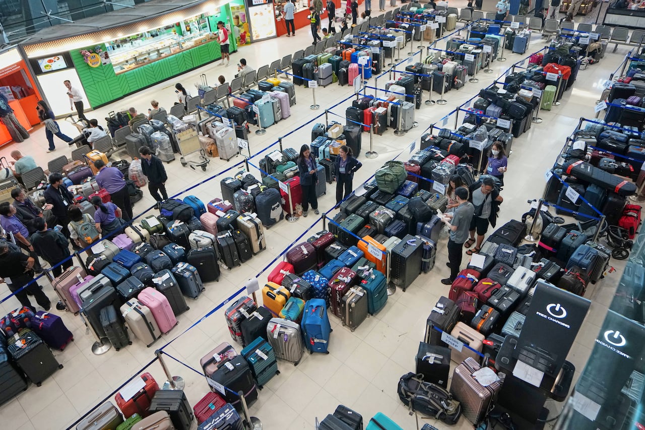 A large room shot from above full of tagged luggage.