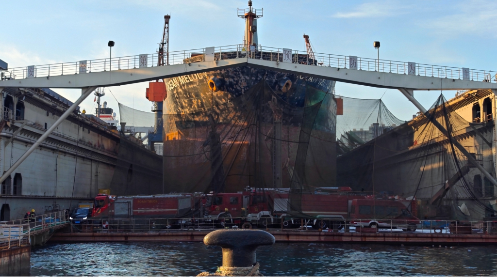 In this photo released by Xinhua News Agency, firefighters vehicles parked near a repair cargo ship after it caught fire at a port in Qingdao, east Chinas Shandong Province, Thursday. (AP)