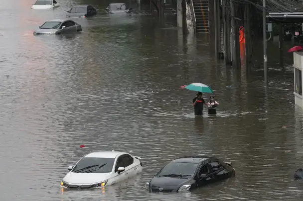 The streets are flooded after heavy rain in Bangkok, Thailand, Saturday. (AP Photo)