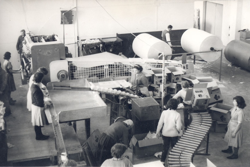 Women standing around packing machinery