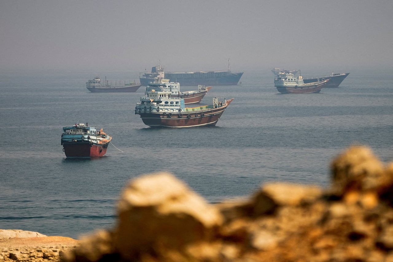Ships are seen at sea from rocks.