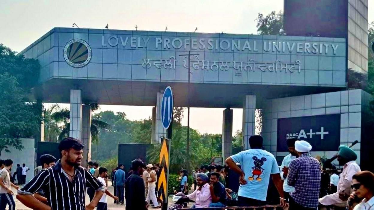 People standing outside the Lovely Professional University campus in Punjab's Phagwara 