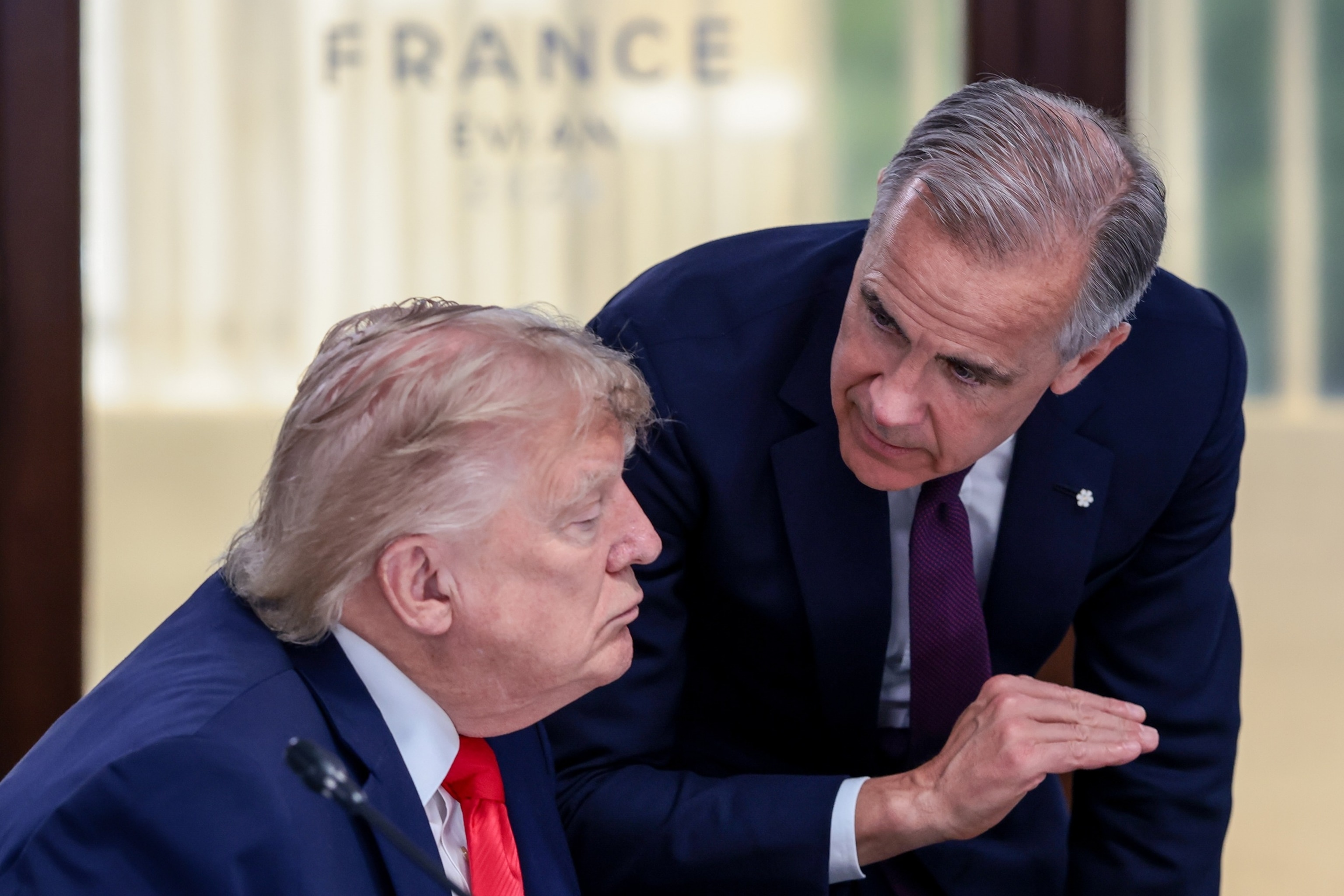 President Donald Trump speaks with Canadian Prime Minister Mark Carney at a working lunch with leaders of G7 and the Middle East, in Evian-les-Bains, France, June 16, 2026.Evelyn Hockstein/Pool via AP