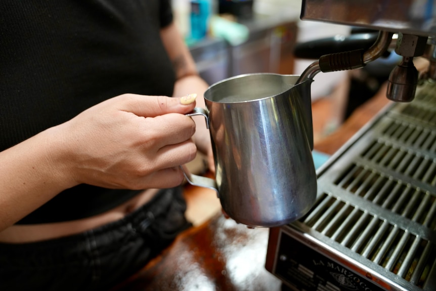 close up of hands making a coffee