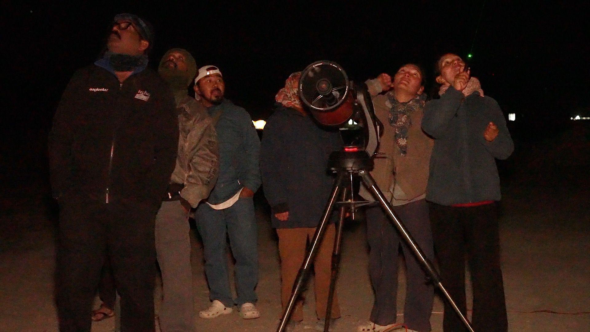 Tsering Yangdol points laser at the sky to help tourists spot stars visible to the naked eye
