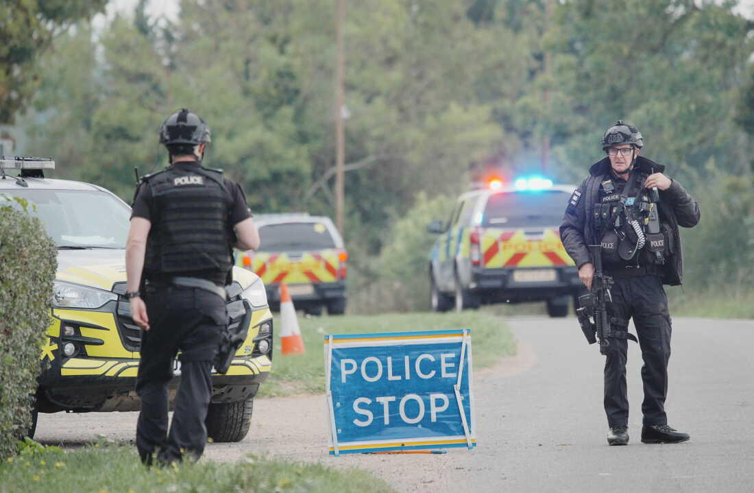 Police stand at a road block on the road to RAF Fairford after an incident, in Whelford, England, Sunday, Sept. 27, 2026,