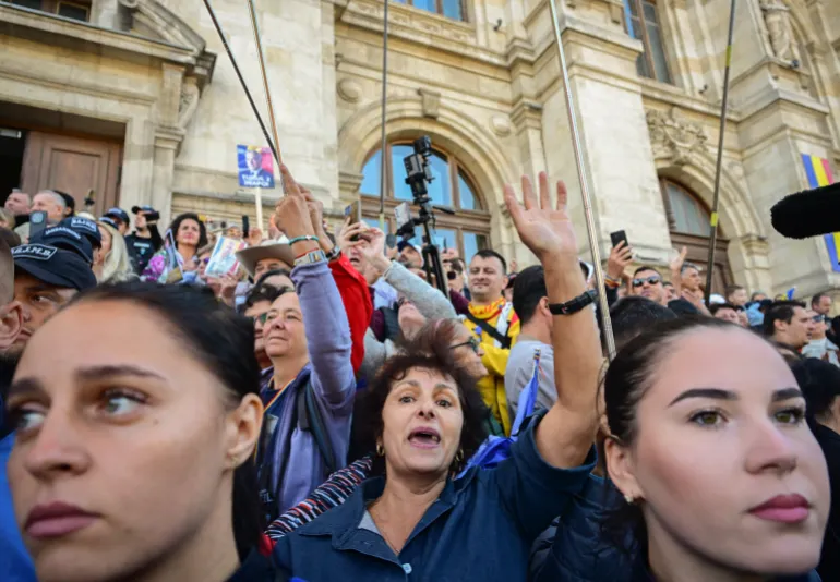 Supporters of Romania’s far-right politician and former presidential candidate Calin Georgescu, not in picture, cheer as he leaves the Court of Appeal in Bucharest on September 28, 2026, following a new hearing in the case in which he and other defendants are accused of actions against Romania’s constitutional order [AFP]