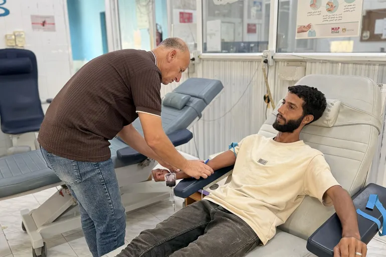 Blood is drawn from a patient for testing as Gaza’s medical staff try to treat patients with limited healthcare resources