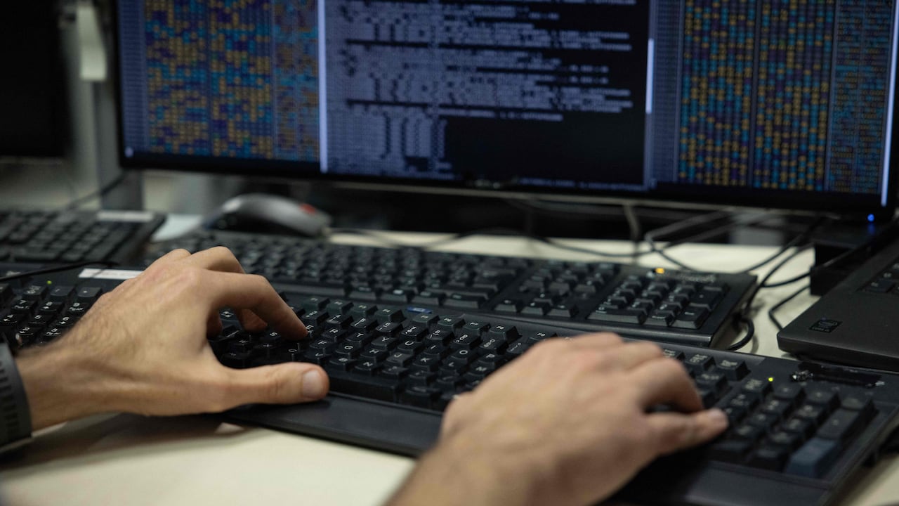 Hands typing at a computer