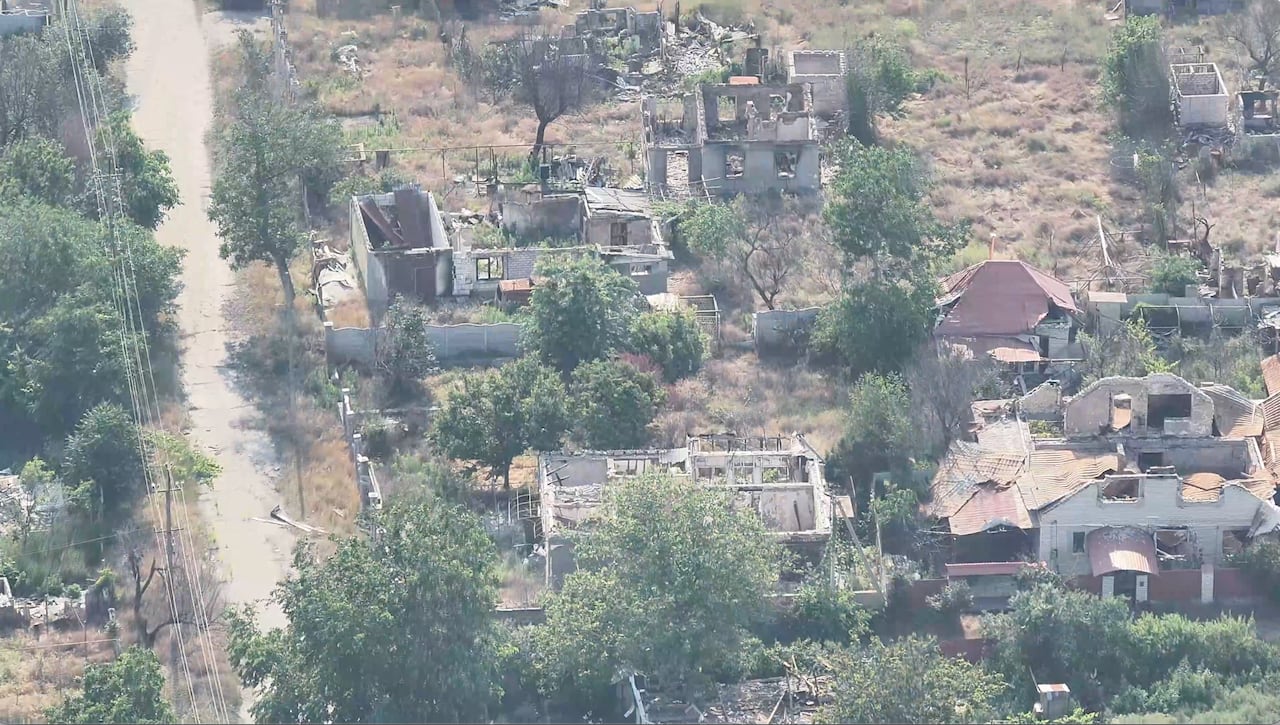 An aerial view shows homes in ruins.