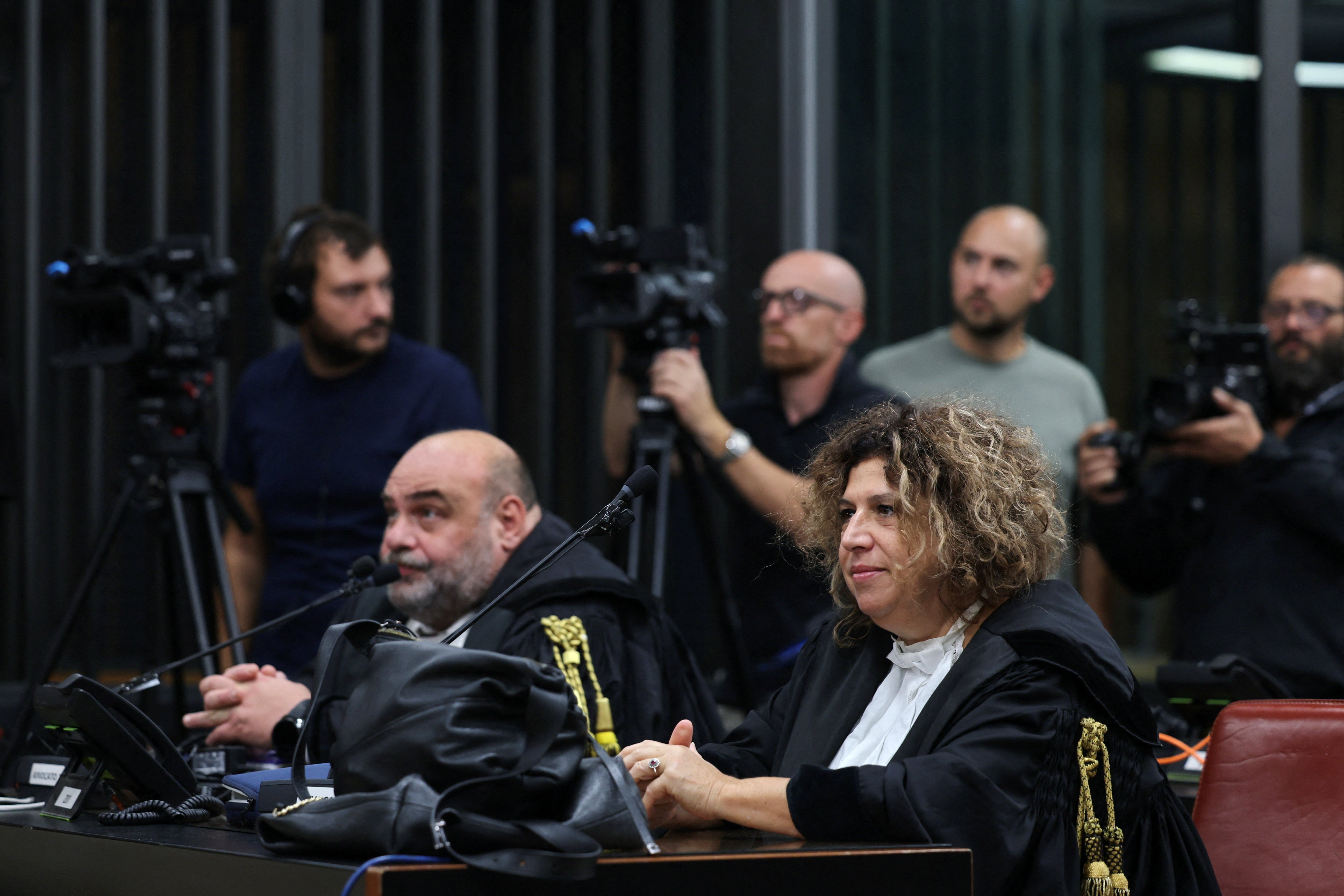Lawyers for the Egyptian security service members look on
