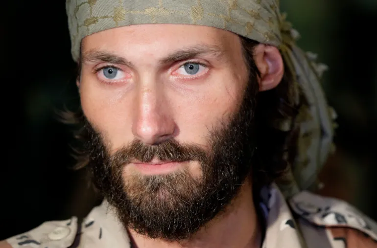 Matthew VanDyke, who spent months in Libyan prisons before joining rebel forces who opposed dictator Moammar Gadhafi, speaks with reporters after his flight arrived at Baltimore-Washington International Airport, Saturday, November 5, 2011.