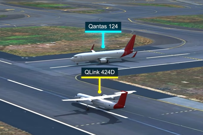 A recreation of a near collision between two qantas planes on a runway. 